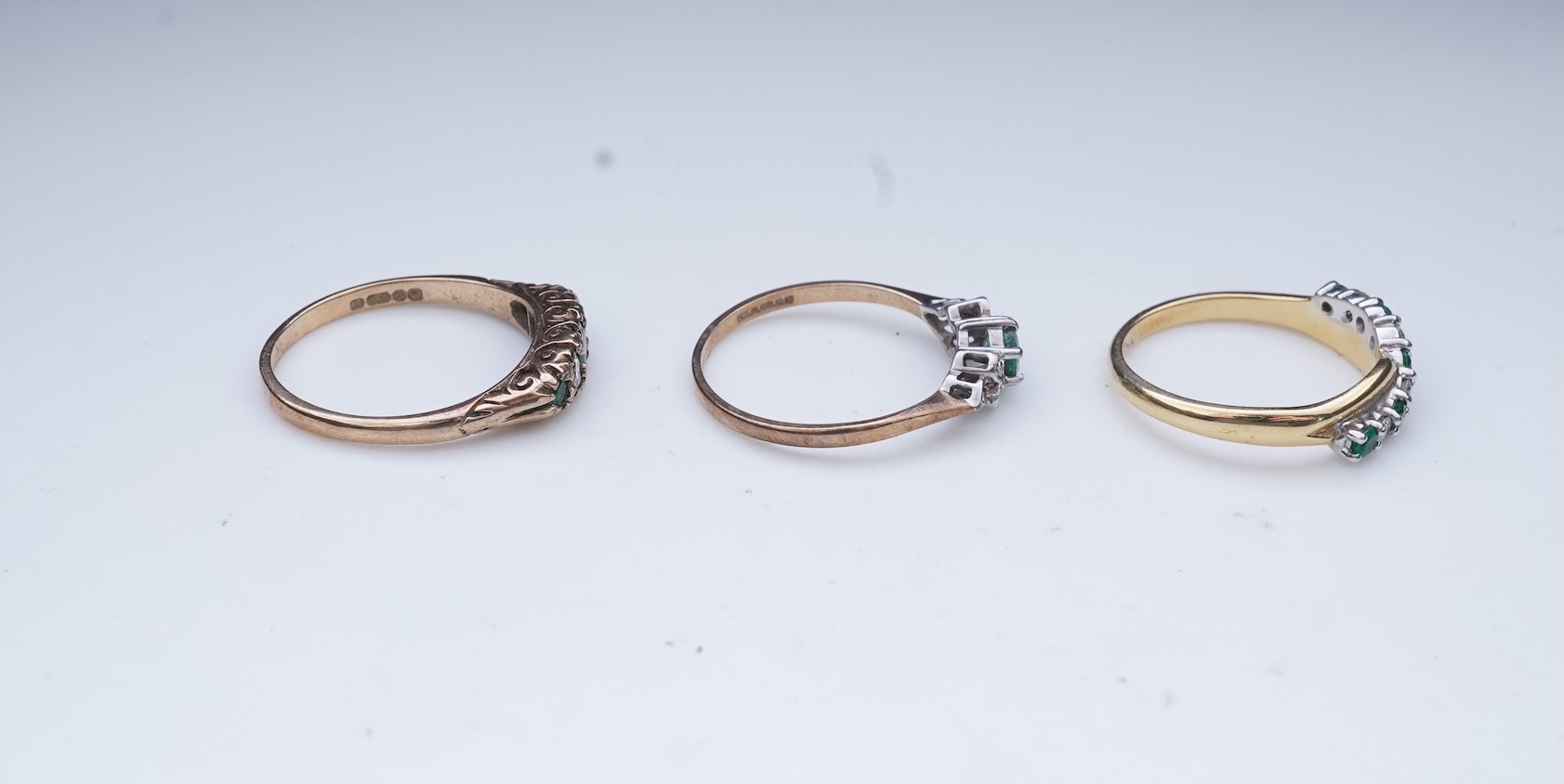 Three emerald and diamond rings